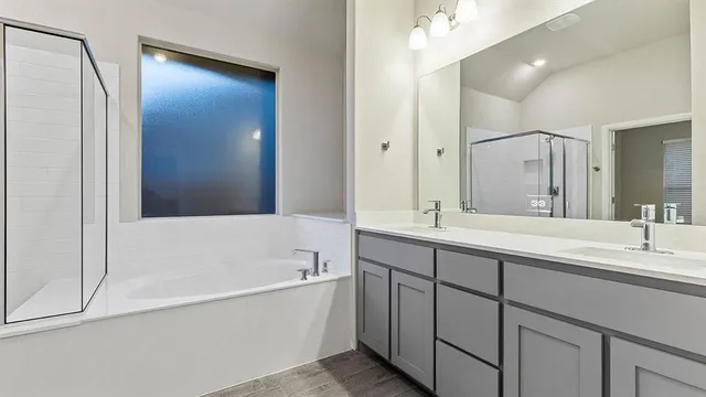a bathroom with a tub sink and mirror