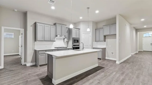 a front view of a house with a garden and plants