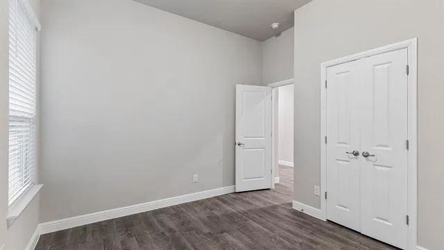 an empty room with wooden floor