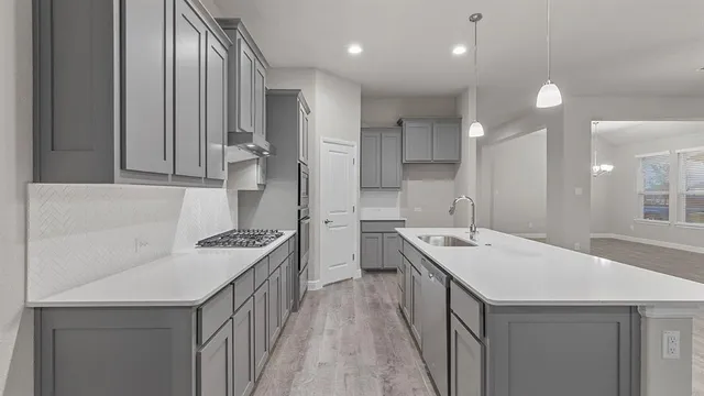a kitchen with a sink stainless steel appliances and cabinets