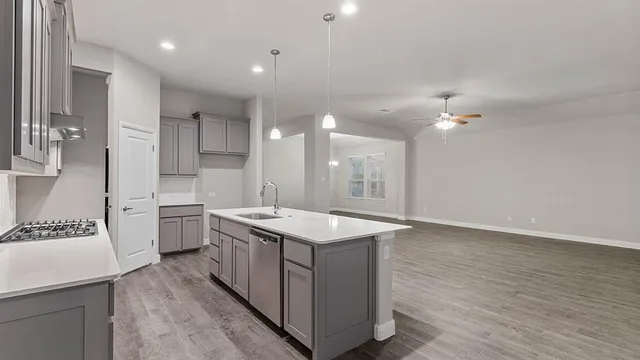 a kitchen with a sink stove and cabinets