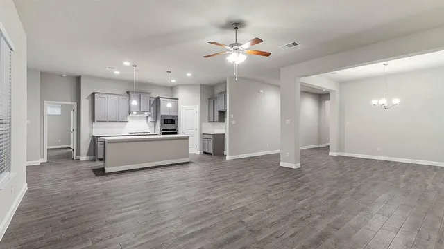 a view of a kitchen with a sink stainless steel appliances and cabinets