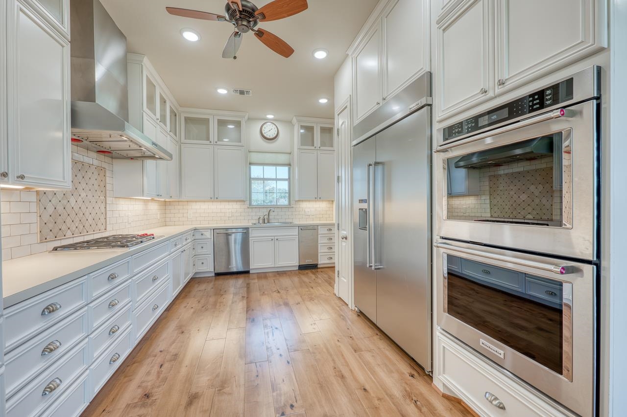 229 Eagle Ridge Burnet, TX 78611 - Photo 11 of 30 a large kitchen with a stove top oven