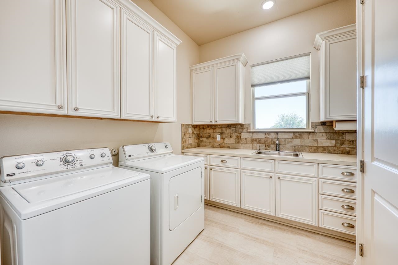 229 Eagle Ridge Burnet, TX 78611 - Photo 17 of 30 a view of washer and dryer with kitchen view
