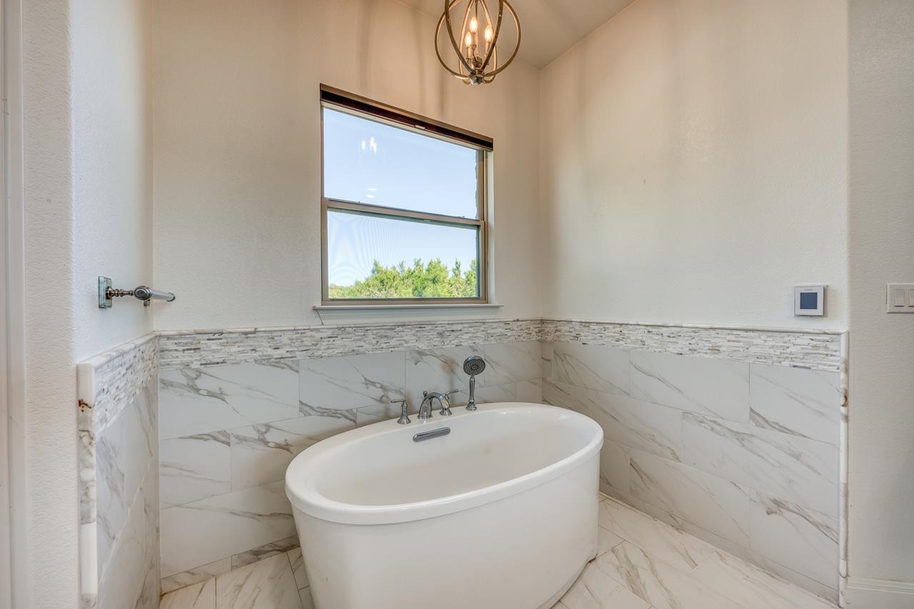 229 Eagle Ridge Burnet, TX 78611 - Photo 23 of 30 a white bath tub sitting next to a white sink