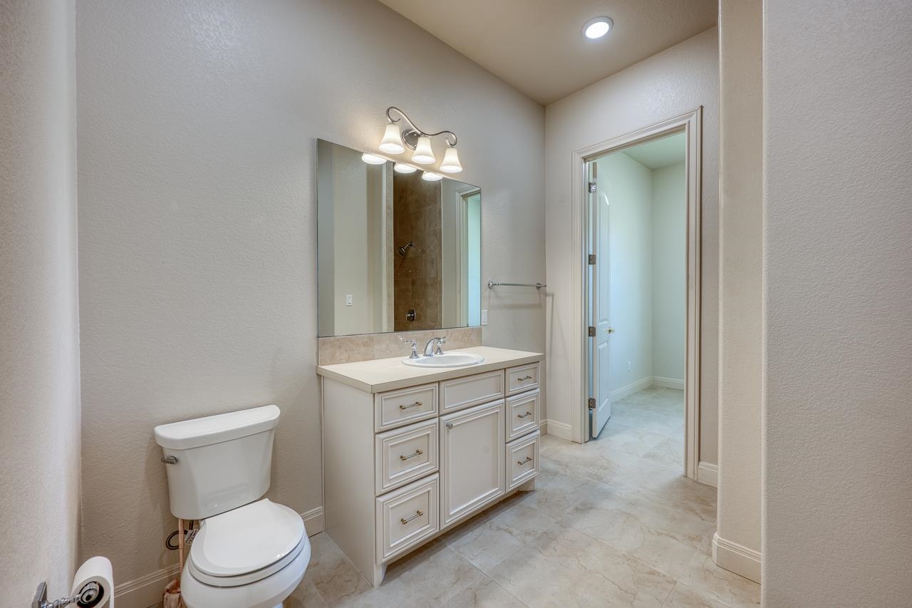 229 Eagle Ridge Burnet, TX 78611 - Photo 25 of 30 a bathroom with a toilet sink and mirror