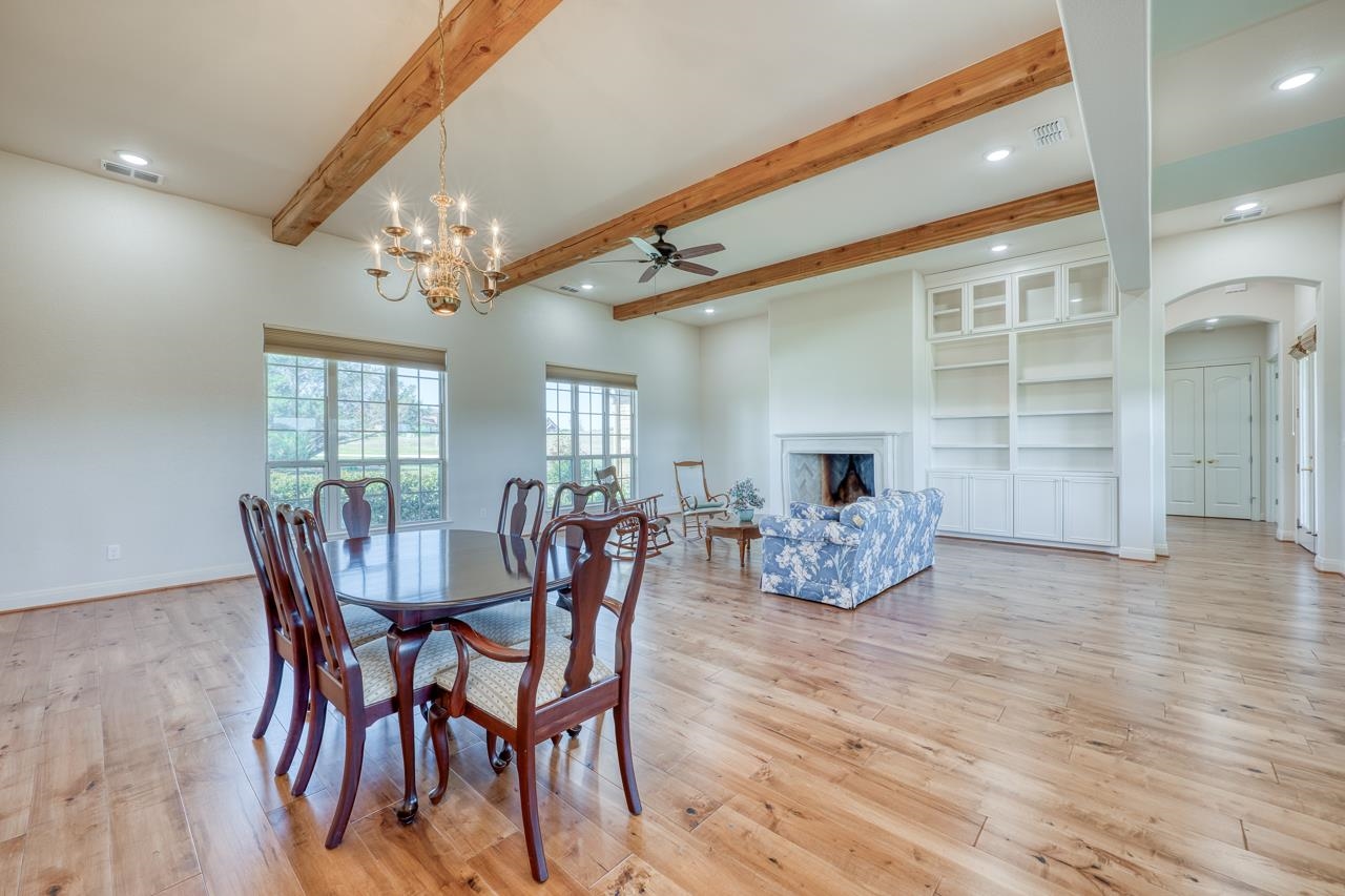 229 Eagle Ridge Burnet, TX 78611 - Photo 7 of 30 a dining room with furniture a chandelier and wooden floor