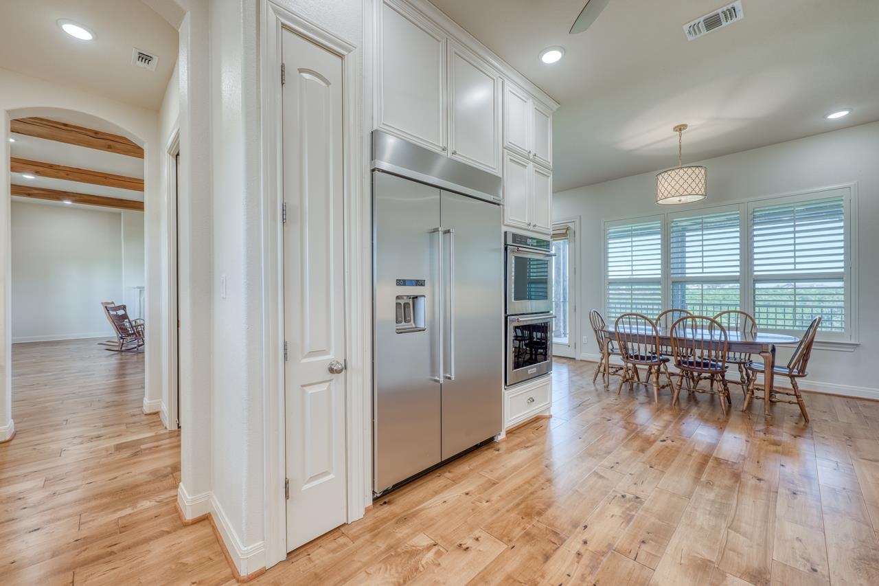 229 Eagle Ridge Burnet, TX 78611 - Photo 10 of 30 an open kitchen and dining area with wooden floor