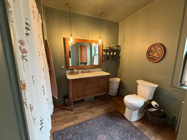 a bathroom with a toilet a sink and a mirror