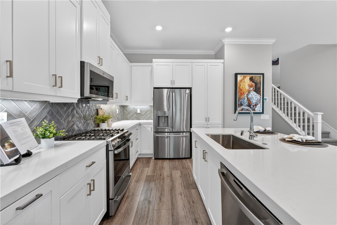 752 Sunrise Road Rancho Mission Viejo, CA 92694 - Photo 10 of 73 a kitchen with stainless steel appliances granite countertop a sink stove and refrigerator