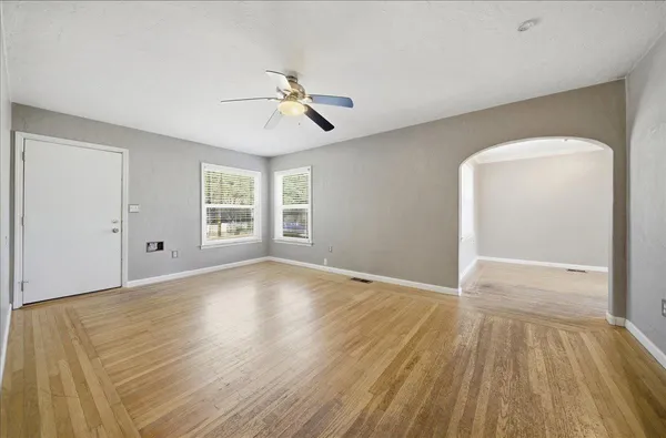 a large kitchen with stainless steel appliances granite countertop a lot of counter space and wooden floor