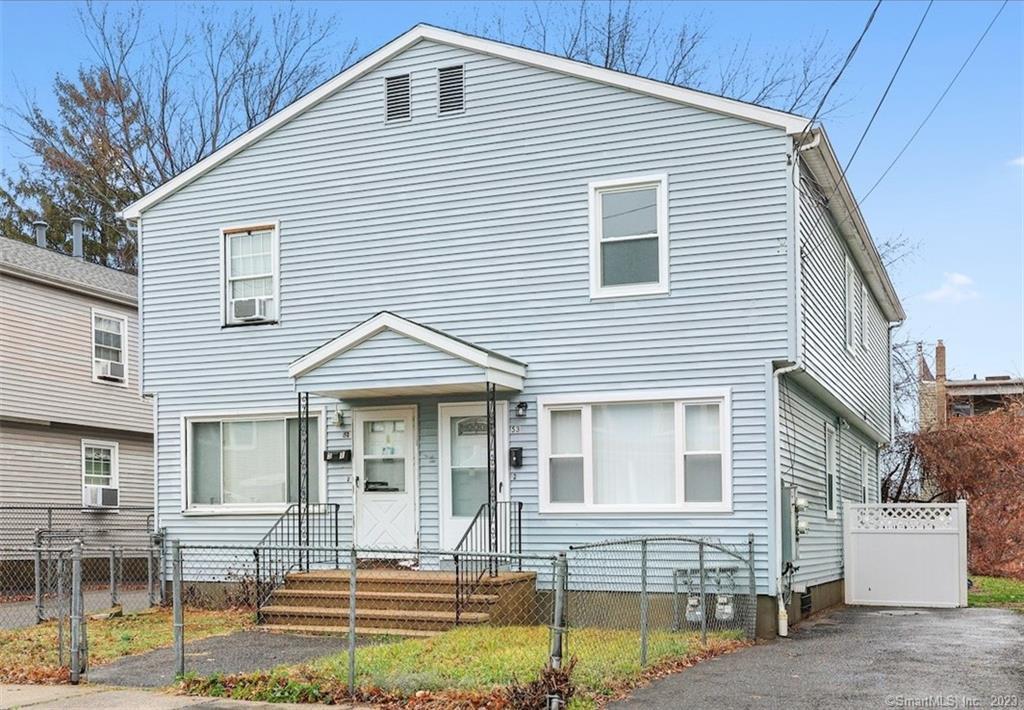 53 Adams Street Bridgeport, CT 06607 - Photo 1 of 1 a front view of a house with a yard