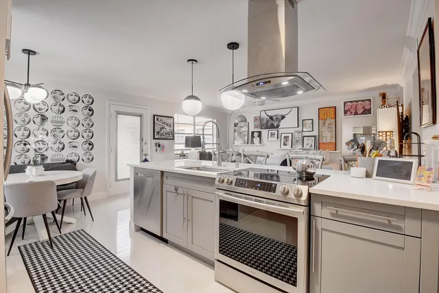 a kitchen with stainless steel appliances a sink stove and cabinets