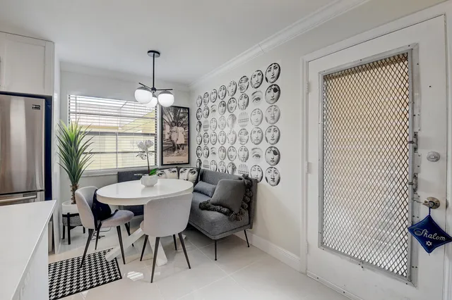 a view of a dining room and hall with furniture