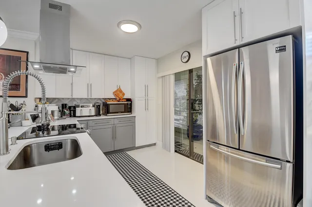 a kitchen with a sink cabinets and window