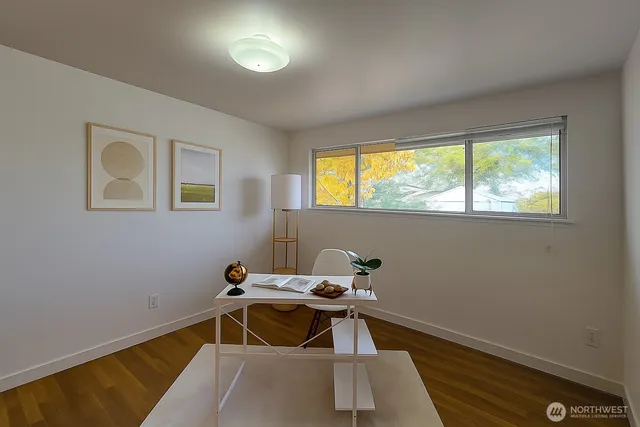 a view of a workspace with furniture and window