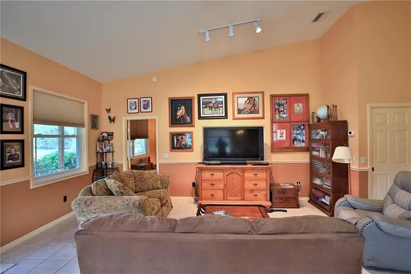 a bedroom with a bed a chandelier and dresser