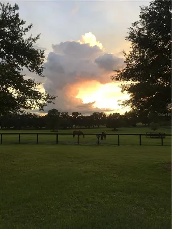 a view of house with backyard and outdoor seating