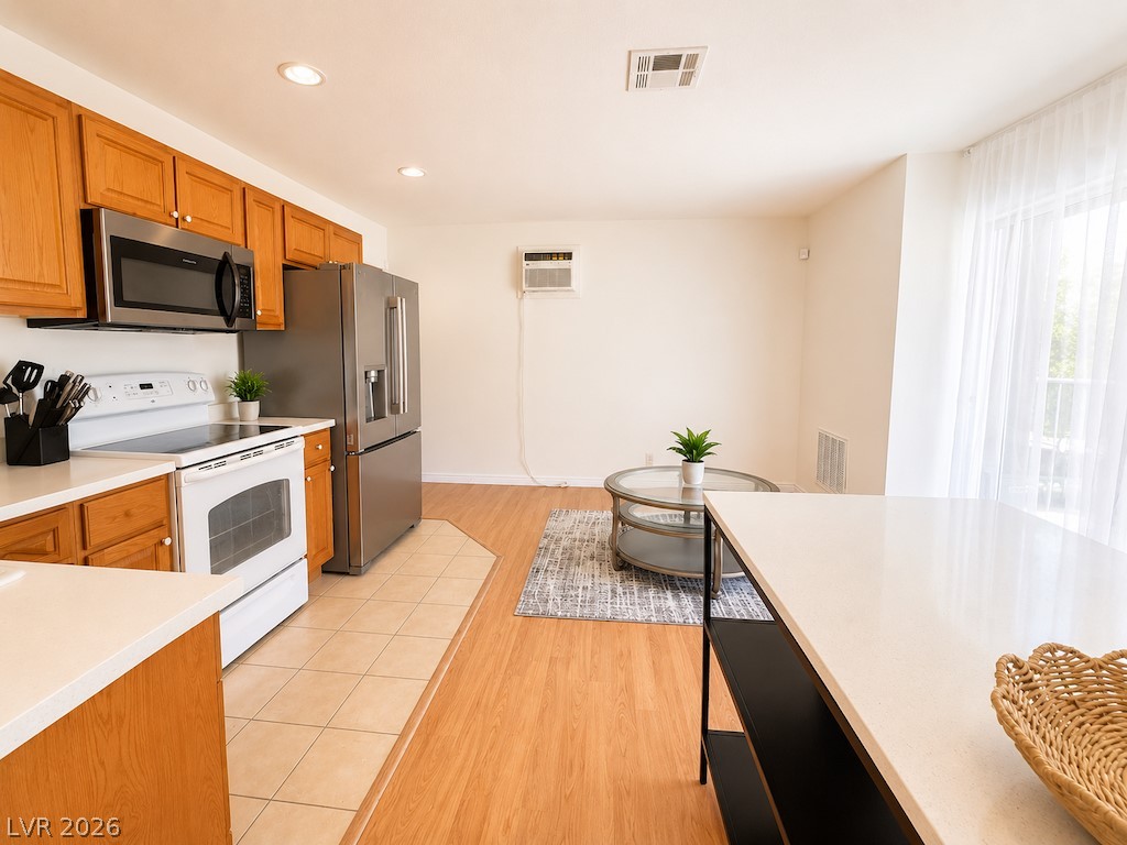 3010 East Viking Road Las Vegas, NV 89121 - Photo 39 of 48 A well-appointed kitchen features warm cabinetry, contrasting appliances, and seamless access to a bright living space.