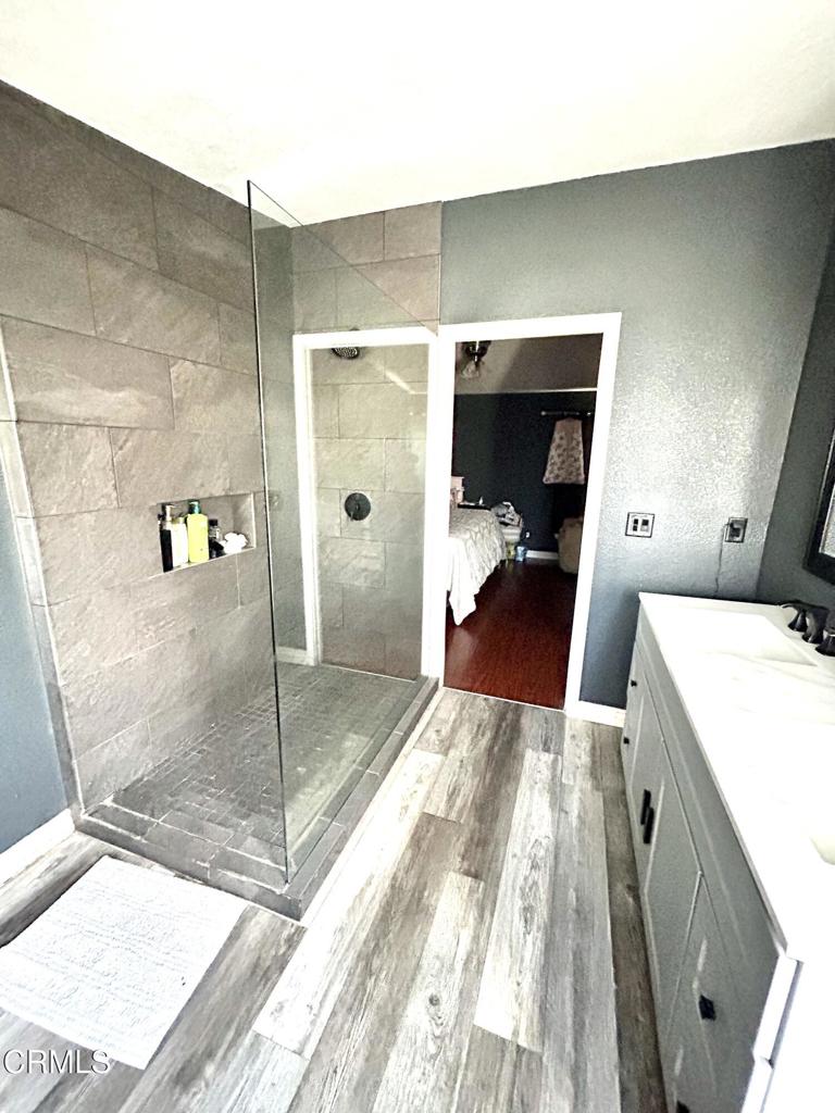 2400 East Pleasant Valley Road, Unit 108 Oxnard, CA 93033 - Photo 11 of 19 a bed room with a bed and glass door