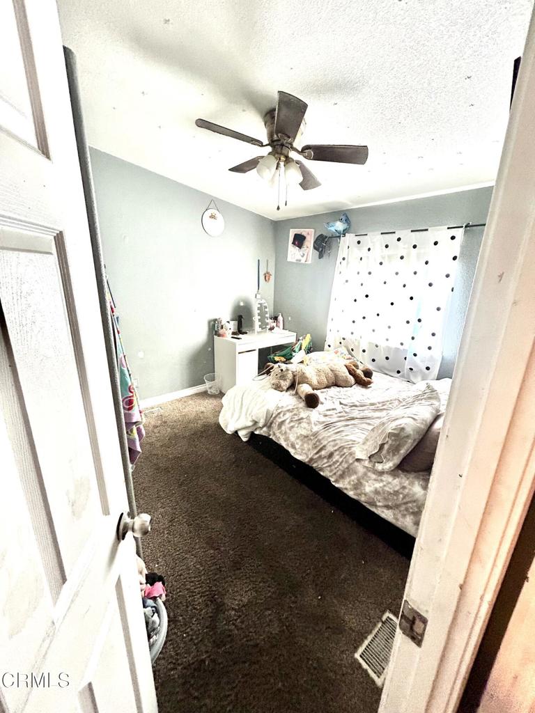 2400 East Pleasant Valley Road, Unit 108 Oxnard, CA 93033 - Photo 14 of 19 a bedroom with a bed and a window