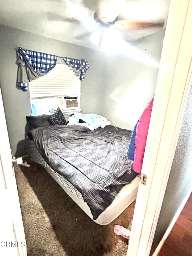 2400 East Pleasant Valley Road, Unit 108 Oxnard, CA 93033 - Photo 15 of 19 a bed sitting in a bedroom next to a window