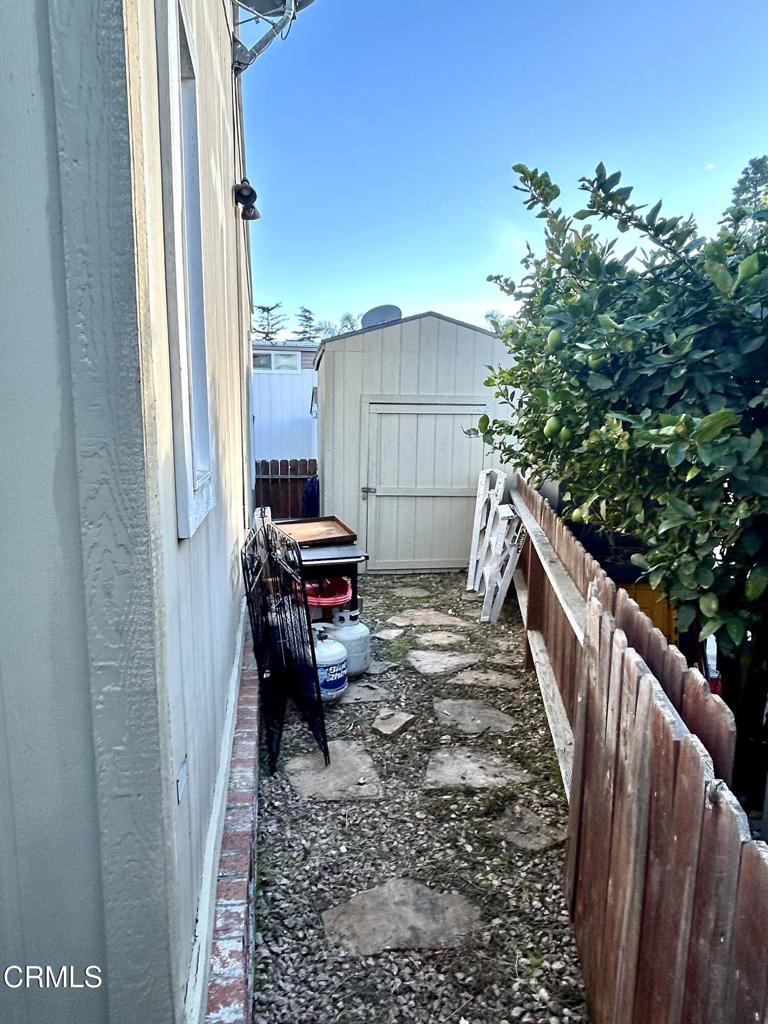 2400 East Pleasant Valley Road, Unit 108 Oxnard, CA 93033 - Photo 18 of 19 a balcony with wooden floor outdoor seating and stairs