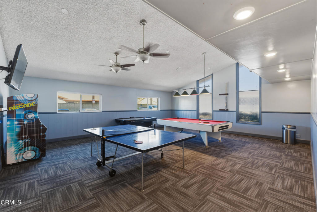 2400 East Pleasant Valley Road, Unit 108 Oxnard, CA 93033 - Photo 26 of 29 a room with furniture and air hockey table
