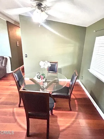 a view of a dining room with furniture and wooden floor