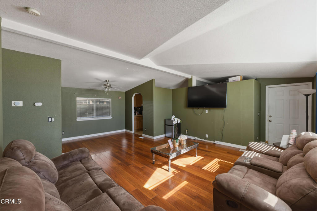 2400 East Pleasant Valley Road, Unit 108 Oxnard, CA 93033 - Photo 6 of 29 a living room with furniture and a flat screen tv