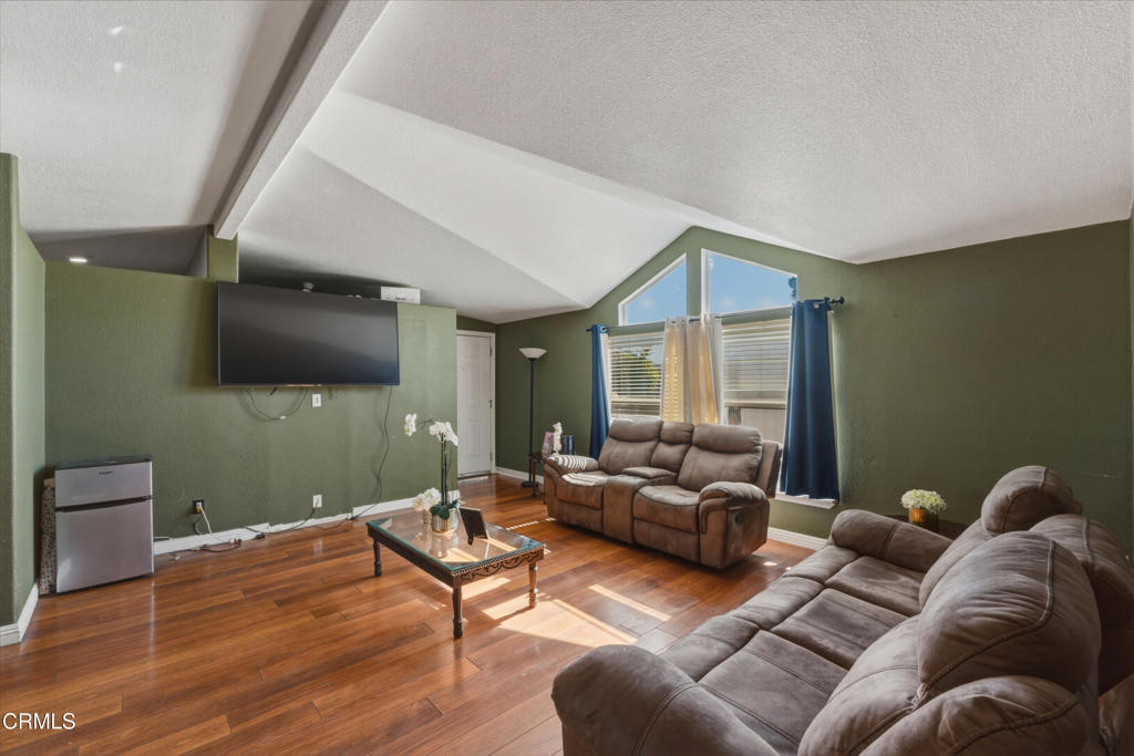 2400 East Pleasant Valley Road, Unit 108 Oxnard, CA 93033 - Photo 7 of 29 a living room with furniture and a flat screen tv