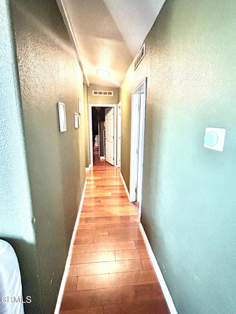 2400 East Pleasant Valley Road, Unit 108 Oxnard, CA 93033 - Photo 9 of 19 a walk in closet with wooden floor
