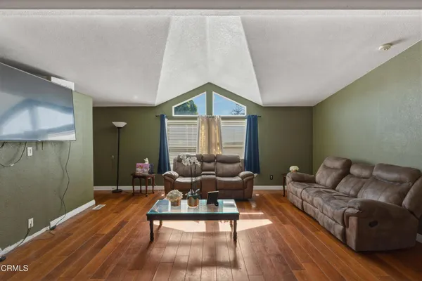a kitchen with stainless steel appliances granite countertop a stove top oven a sink dishwasher and cabinets with wooden floor