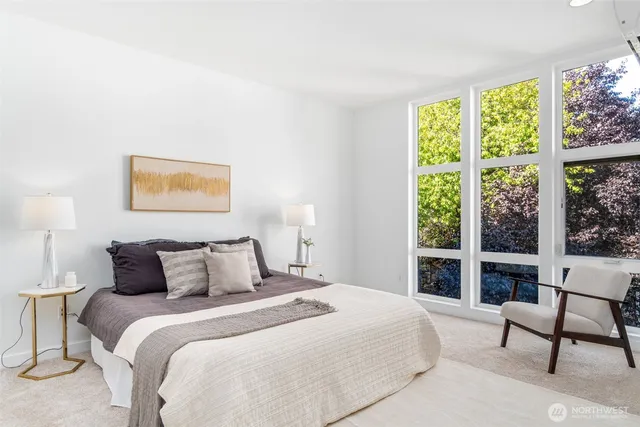 a bedroom with a bed and a lamp