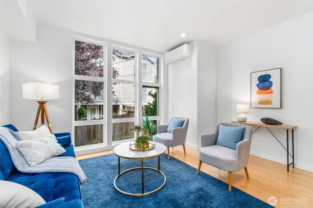 a living room with furniture kitchen view and a fireplace