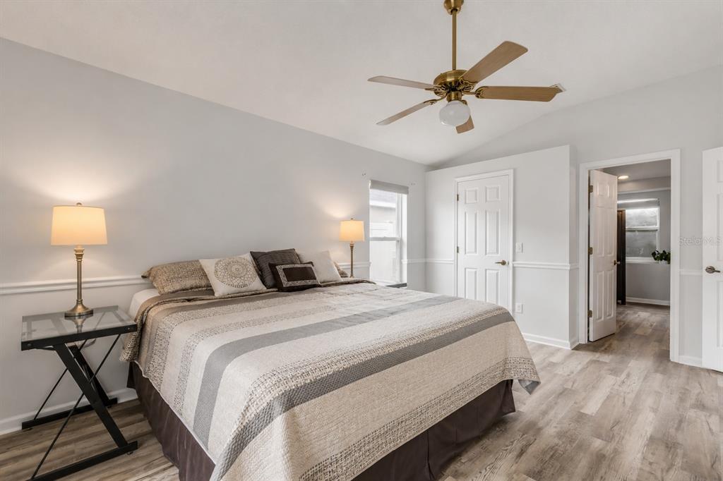 12232 Bronson Way Orlando, FL 32824 - Photo 5 of 32 a bedroom with a bed and a chandelier