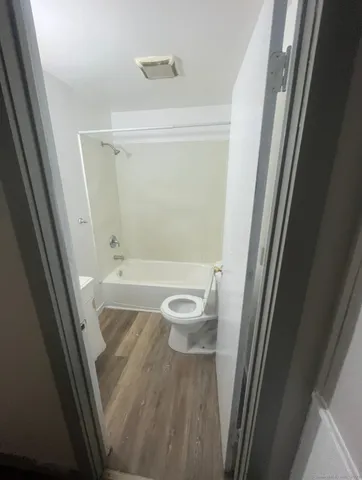 a bathroom with a granite countertop shower and a sink