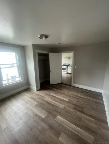 an empty room with windows and closet