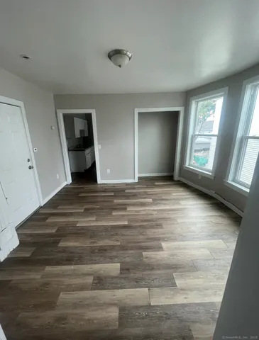 a view of empty room with window and fireplace