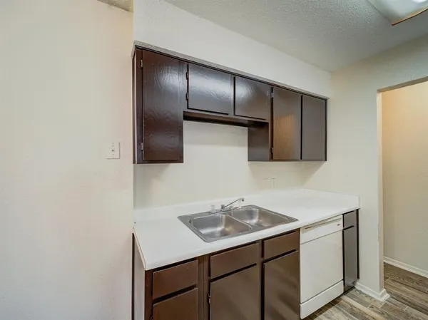 a kitchen with a sink cabinets and stainless steel appliances