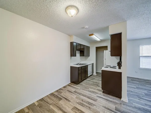 a kitchen with a refrigerator and a stove top oven