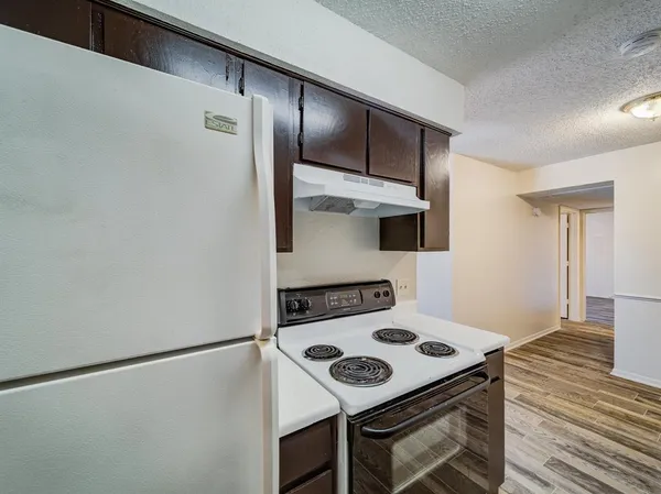 a kitchen with a stove and a refrigerator