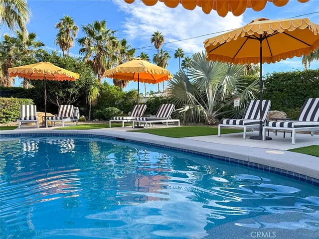 swimming pool view with a garden space