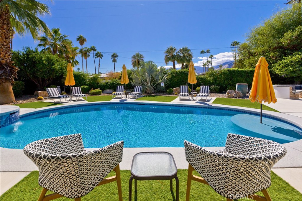 1057 East Marshall Way Palm Springs, CA 92262 - Photo 2 of 64 a view of a patio with swimming pool table and chairs