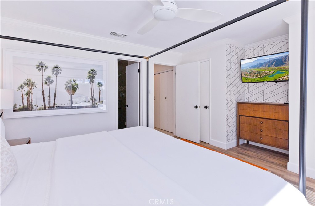 1057 East Marshall Way Palm Springs, CA 92262 - Photo 21 of 64 a bedroom with a bed and a painting on the wall