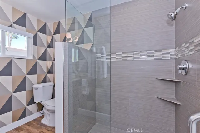 a bathroom with a granite countertop sink mirror and shower