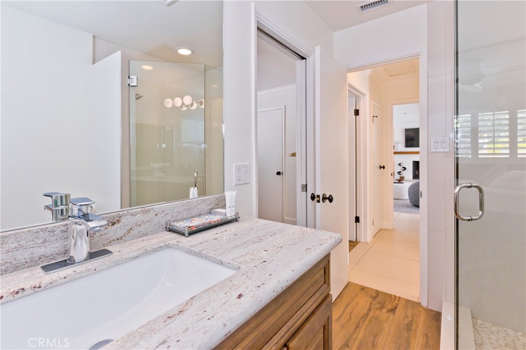 1057 East Marshall Way Palm Springs, CA 92262 - Photo 27 of 64 a bathroom with a granite countertop sink mirror and shower