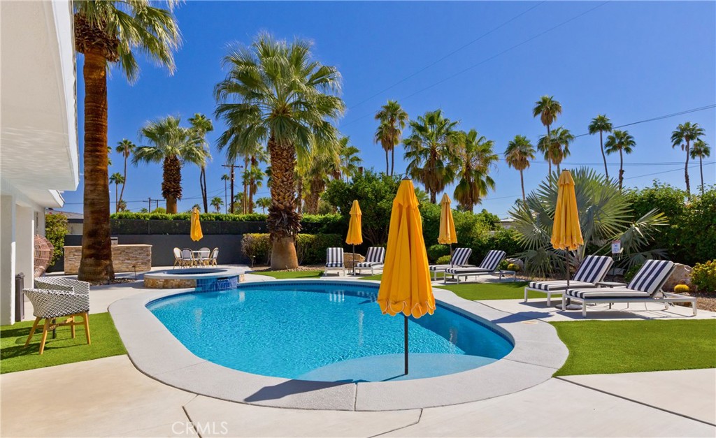 1057 East Marshall Way Palm Springs, CA 92262 - Photo 34 of 64 a view of a swimming pool with lounge chairs