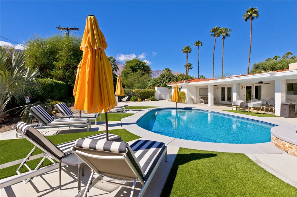 1057 East Marshall Way Palm Springs, CA 92262 - Photo 36 of 64 a view of a swimming pool with a lounge chairs