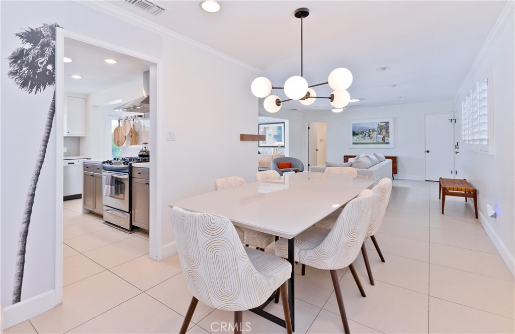 1057 East Marshall Way Palm Springs, CA 92262 - Photo 45 of 64 a view of a dining room kitchen and a chandelier